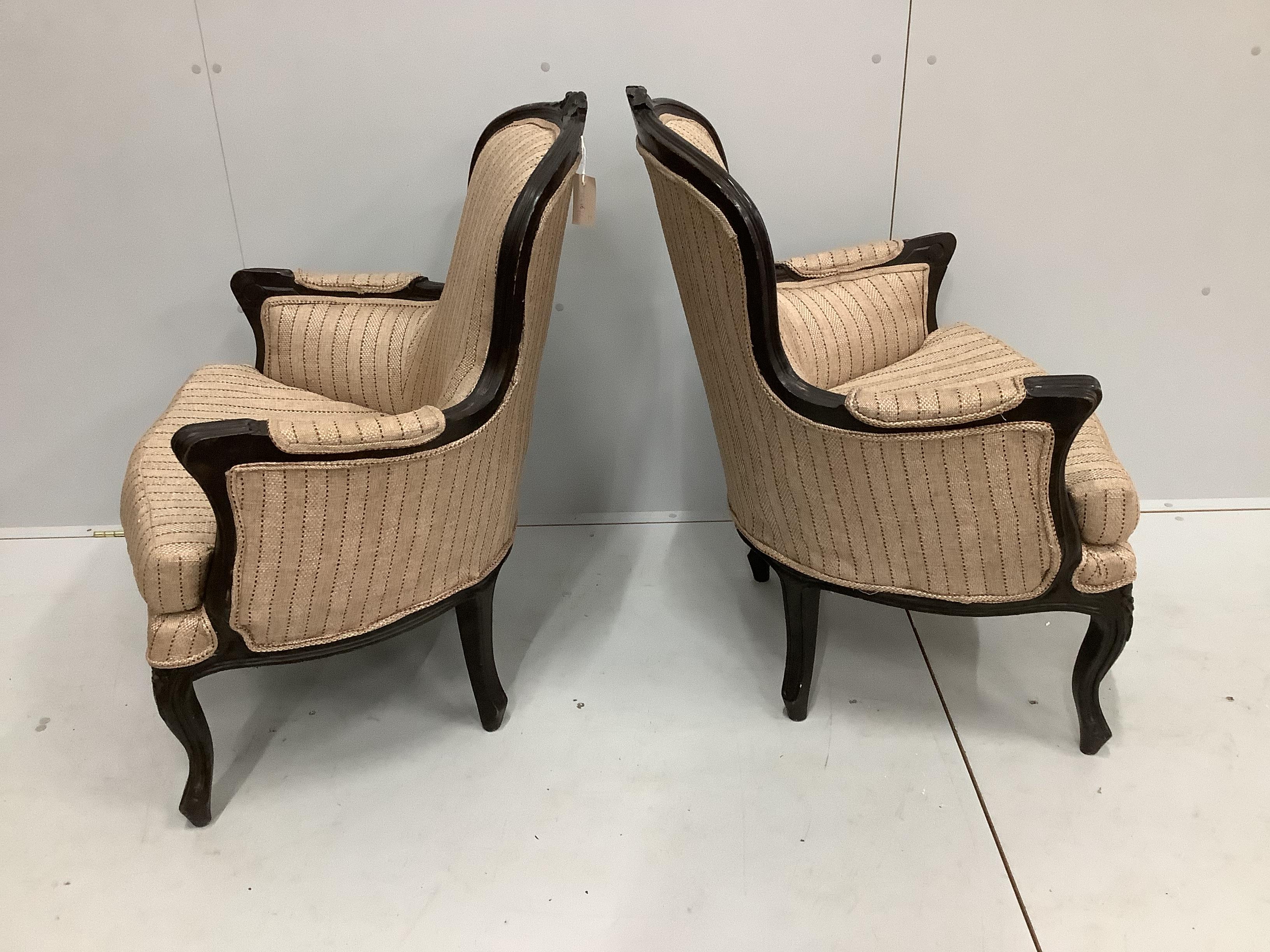 A pair of 19th century French ebonised spoonback armchairs, width 70cm, depth 58cm, height 92cm